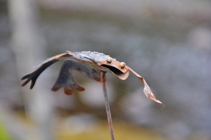 closeup of a metal-handshaped jumping frog
